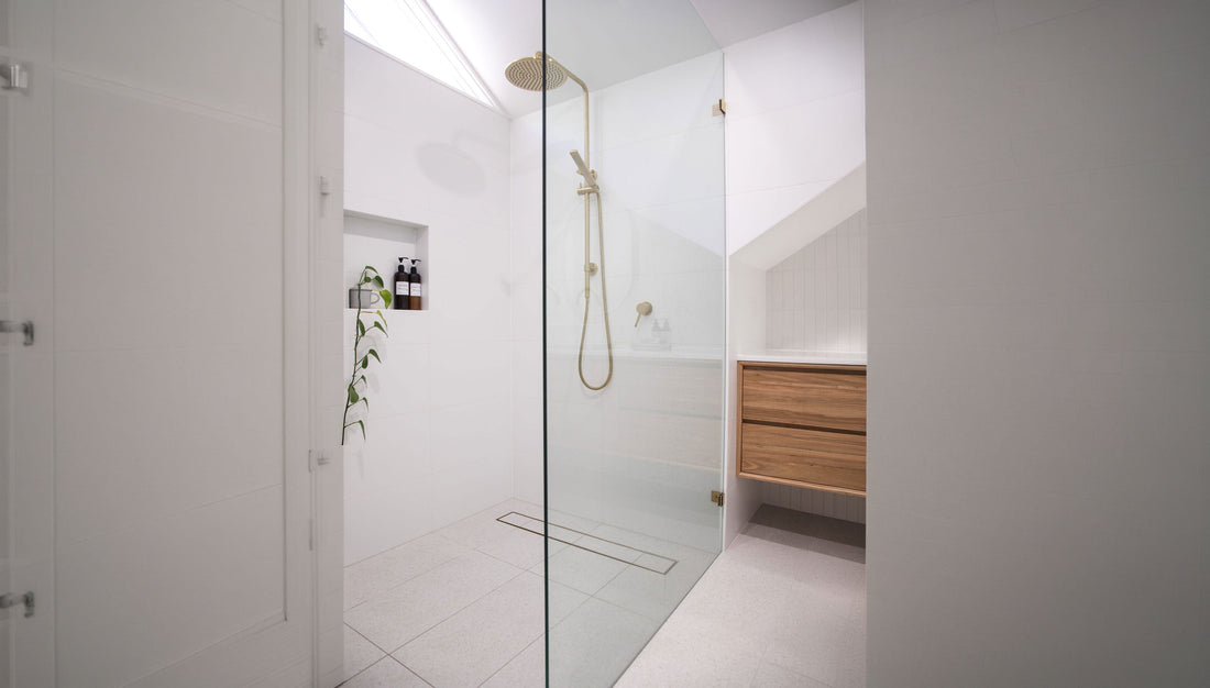 Brass strip drain in luxury modern bathroom renovation