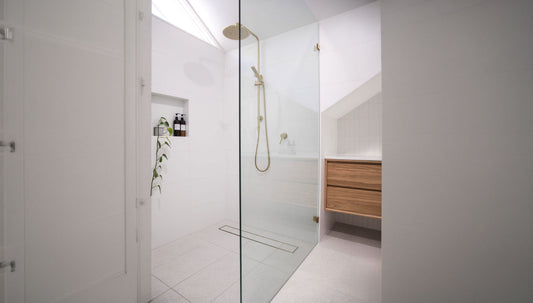 Brass strip drain in luxury modern bathroom renovation