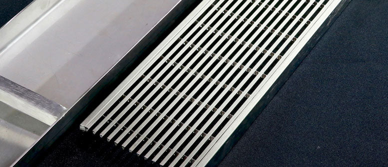Close-up detail of electropolished linear grate drain.
