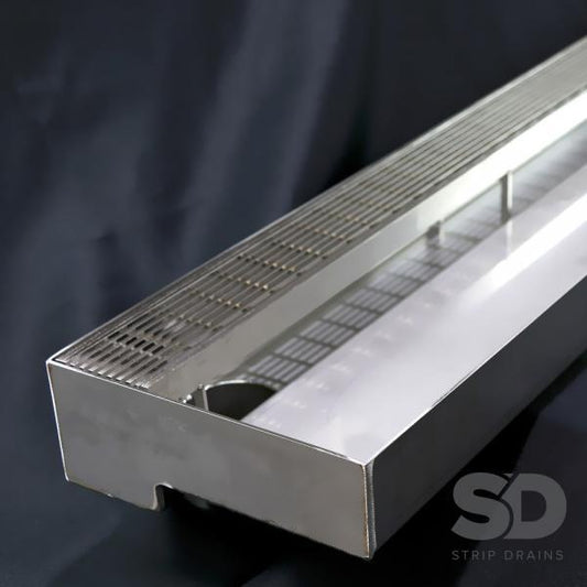 Low Profile Drain made from stainless steel with a grate cover.