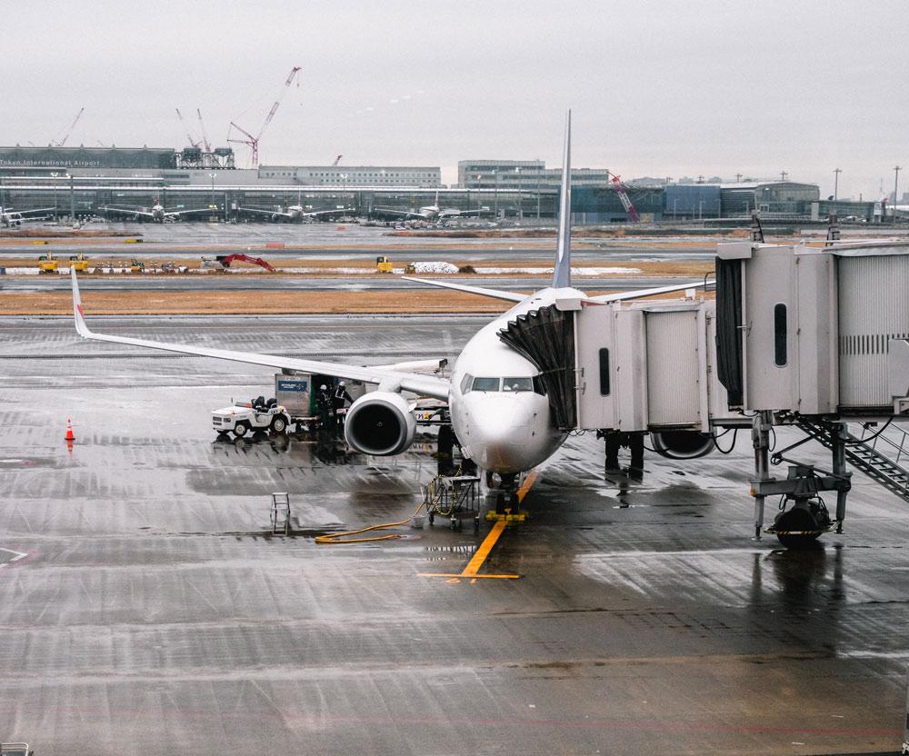 Plane on wet tarmac with drainage